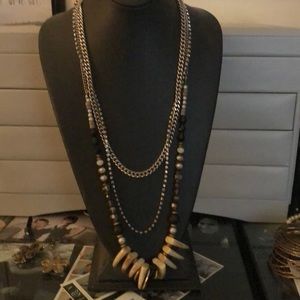 Layered necklace with fake ivory animal teeth